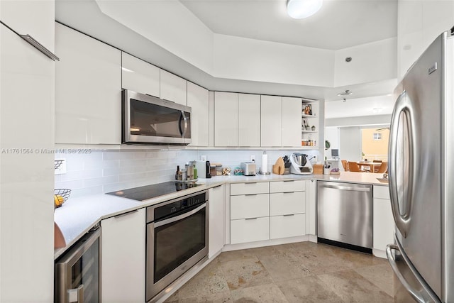 kitchen with stainless steel appliances, wine cooler, modern cabinets, and light countertops