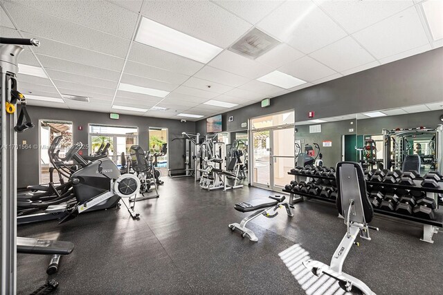 gym featuring visible vents and a paneled ceiling