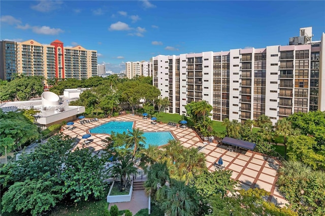 community pool with a patio area and a view of city