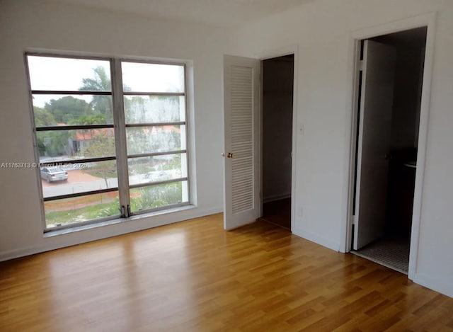 unfurnished bedroom with light wood finished floors