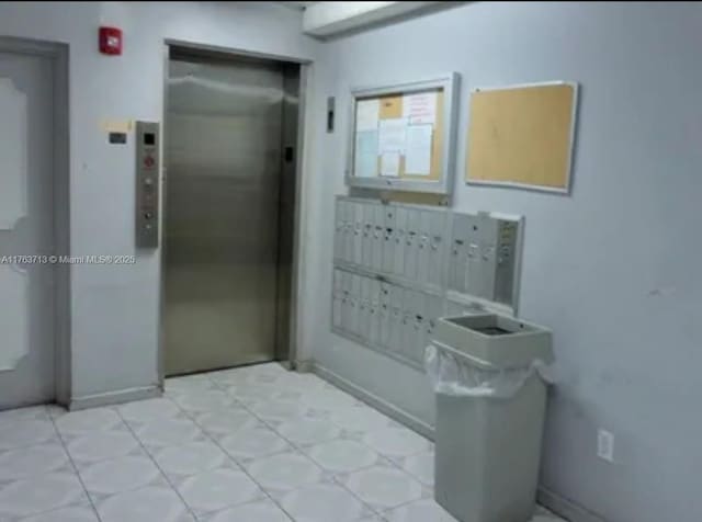 bathroom with mail area and elevator