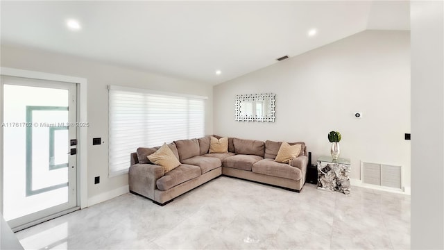 living area featuring visible vents, a healthy amount of sunlight, and vaulted ceiling