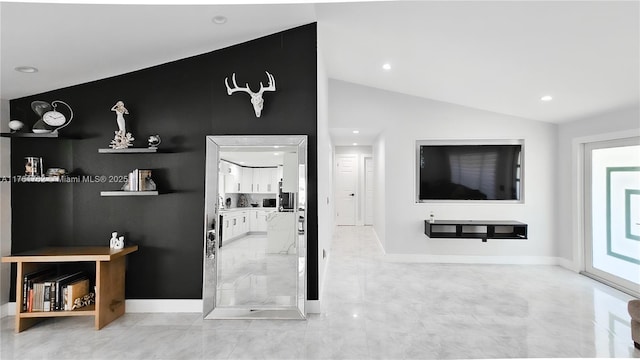 interior space featuring vaulted ceiling, recessed lighting, and baseboards