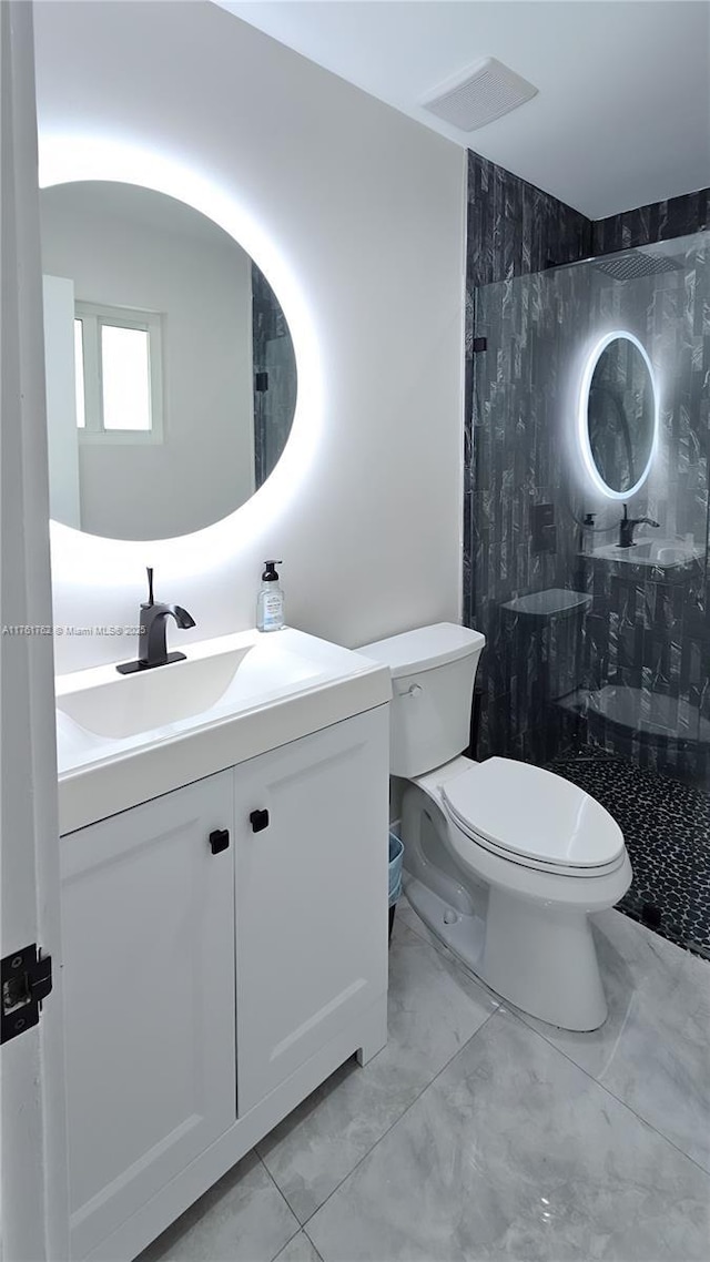 bathroom with visible vents, walk in shower, toilet, marble finish floor, and vanity