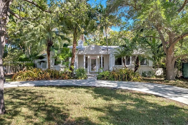 view of front of property with a chimney and a front yard