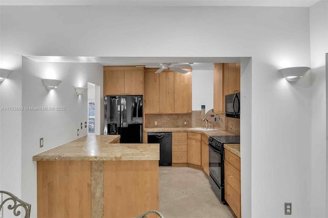 kitchen featuring black appliances, a ceiling fan, a sink, backsplash, and light countertops