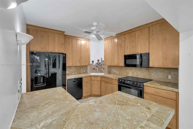 kitchen featuring tasteful backsplash, light brown cabinets, black appliances, a ceiling fan, and a sink