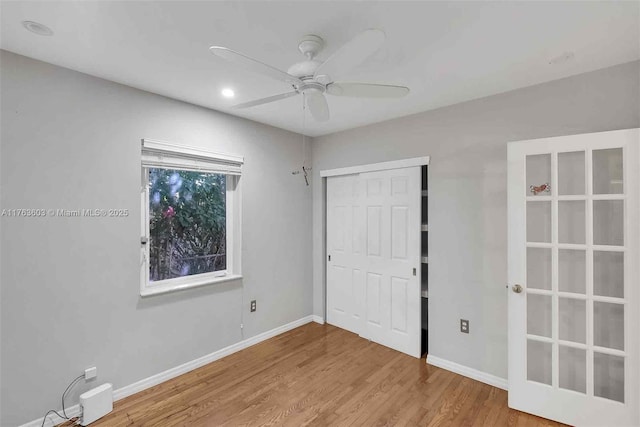 unfurnished bedroom featuring a closet, baseboards, and wood finished floors