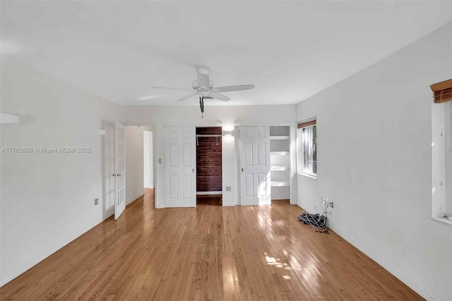 unfurnished bedroom with light wood-style flooring, french doors, and a ceiling fan