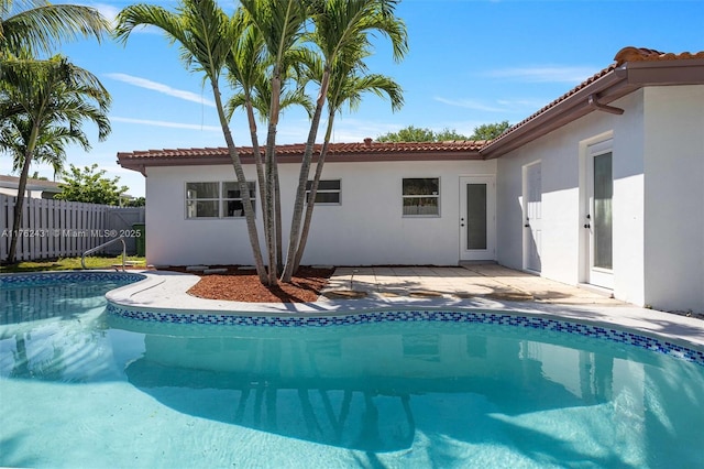 view of swimming pool with a fenced in pool, a patio, and fence