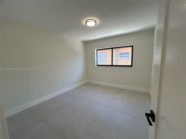 empty room featuring baseboards