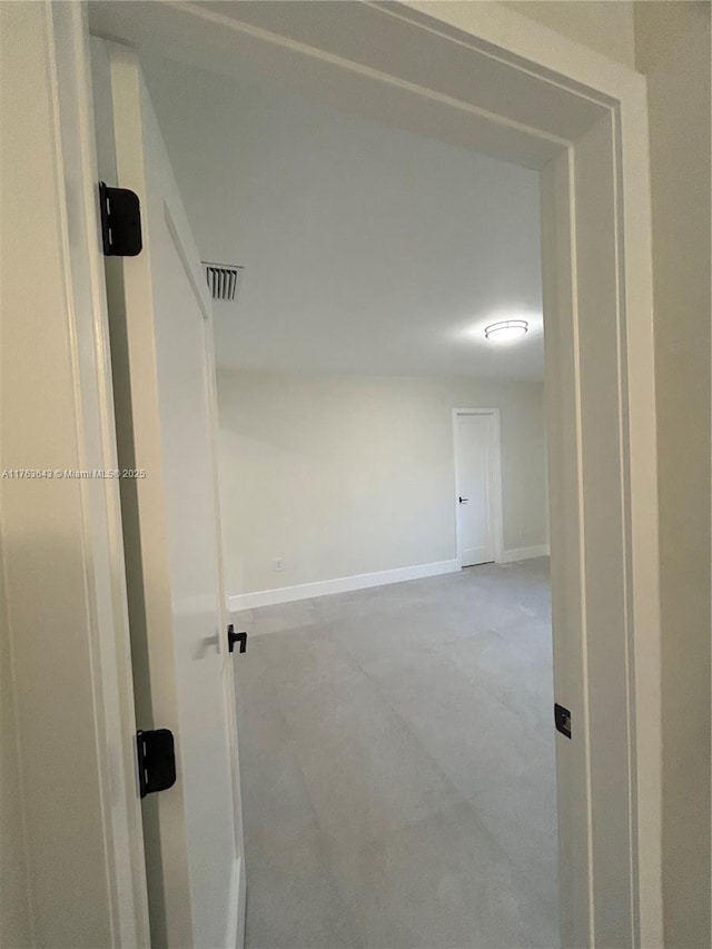 corridor with baseboards and visible vents