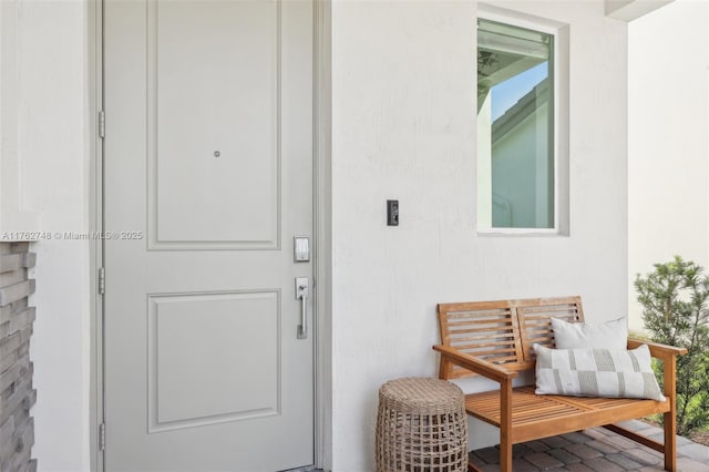 view of exterior entry featuring stucco siding