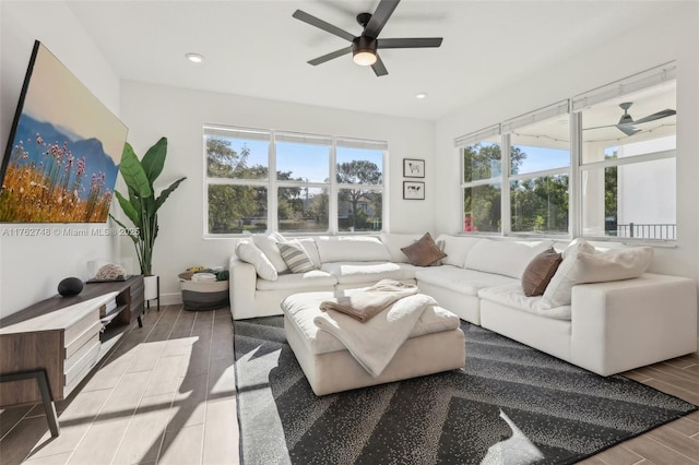 living room featuring wood finish floors, baseboards, recessed lighting, and a ceiling fan