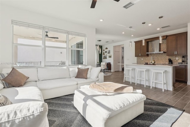 living area featuring visible vents, recessed lighting, and a ceiling fan