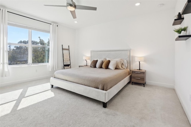 bedroom with recessed lighting, baseboards, light colored carpet, and a ceiling fan