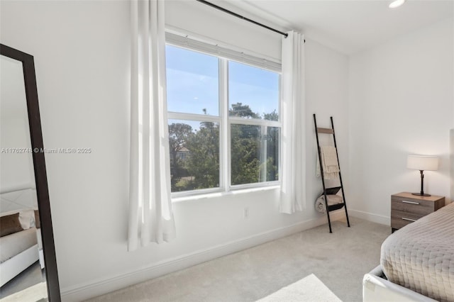 bedroom featuring recessed lighting, multiple windows, light carpet, and baseboards