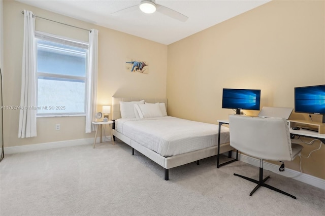 carpeted bedroom with ceiling fan and baseboards