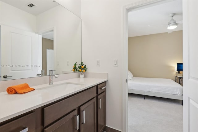 bathroom with ensuite bath, visible vents, vanity, and a ceiling fan