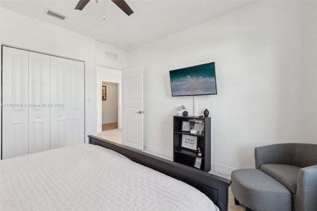 bedroom with a closet, visible vents, baseboards, and a ceiling fan