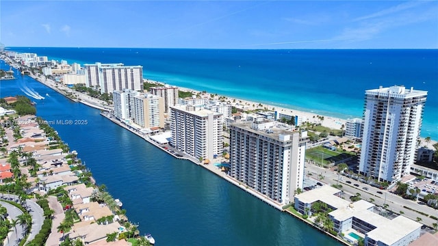 drone / aerial view featuring a water view and a view of city