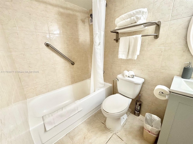 full bathroom featuring tile patterned flooring, toilet, vanity, shower / bath combo, and tile walls