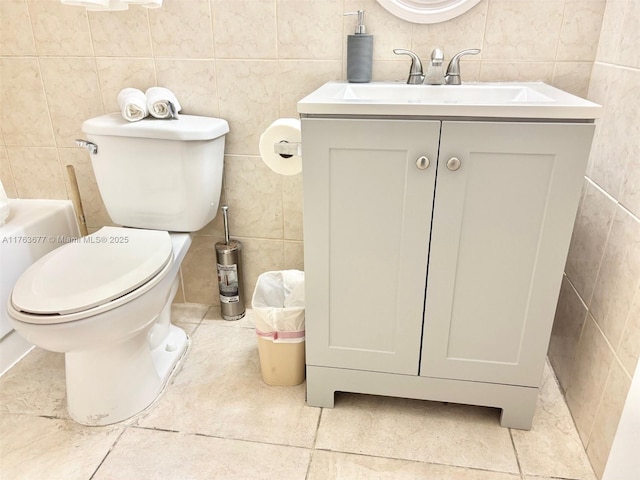 bathroom featuring vanity, tile walls, toilet, and tile patterned flooring