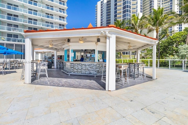 view of patio / terrace featuring a ceiling fan and outdoor dry bar