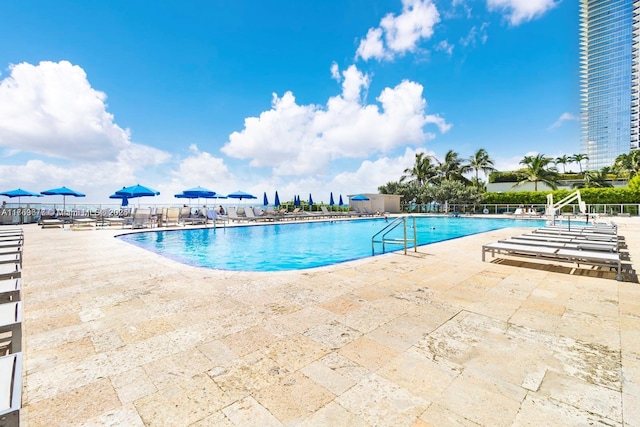 pool featuring a patio and fence