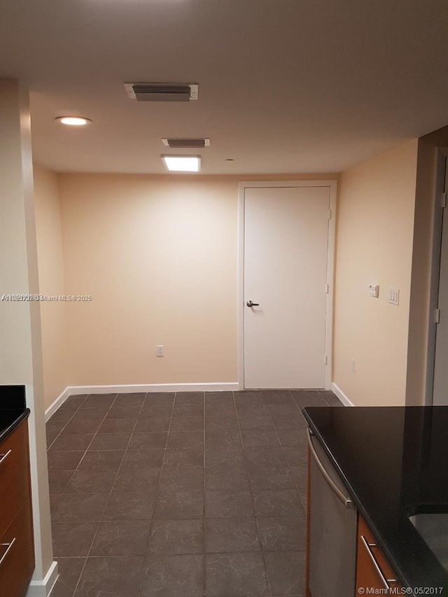 empty room with recessed lighting, visible vents, and baseboards