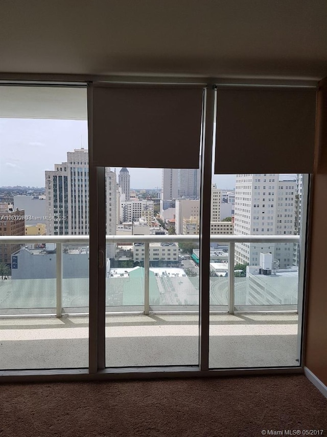 interior space with a view of city and carpet floors