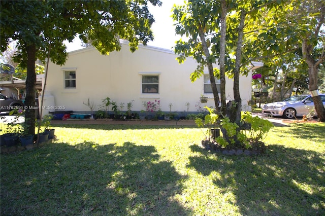 view of property exterior with a yard and stucco siding