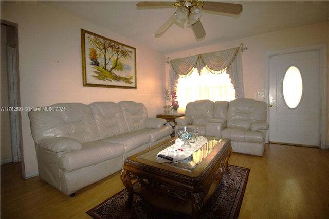 living area with wood finished floors and a ceiling fan