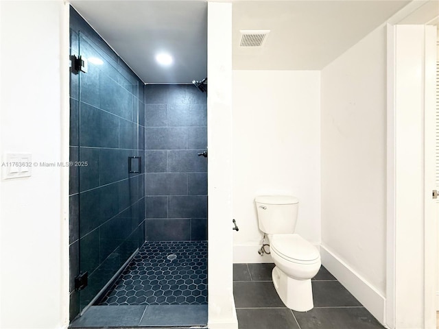 bathroom featuring tile patterned flooring, visible vents, baseboards, toilet, and a stall shower