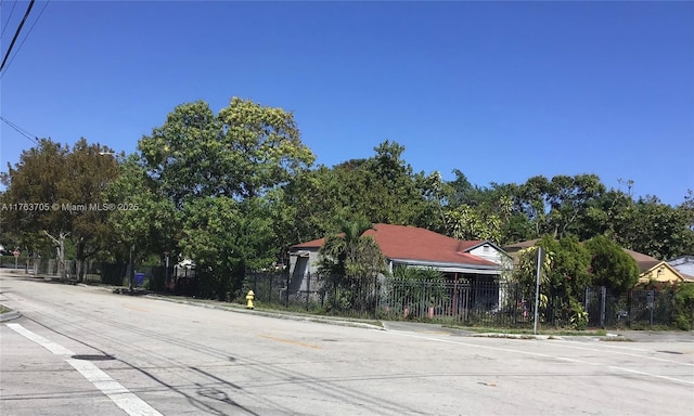 view of road featuring traffic signs, curbs, and sidewalks