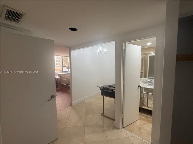 hallway with light tile patterned flooring and visible vents