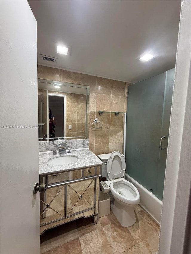 full bath featuring visible vents, toilet, tile walls, and vanity