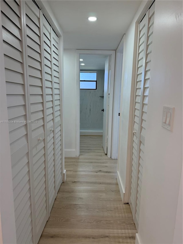 corridor with recessed lighting, baseboards, and light wood-style floors