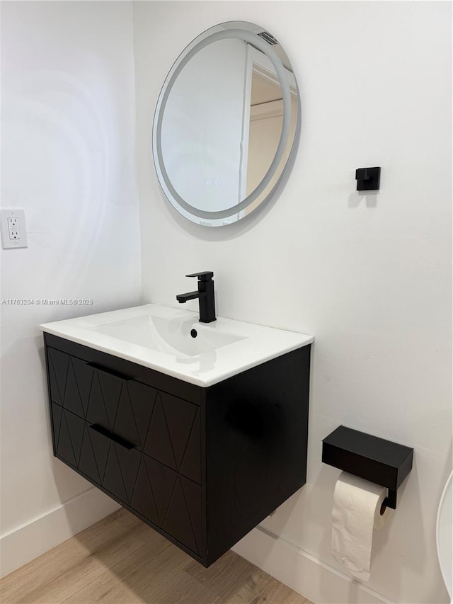 bathroom featuring vanity and wood finished floors