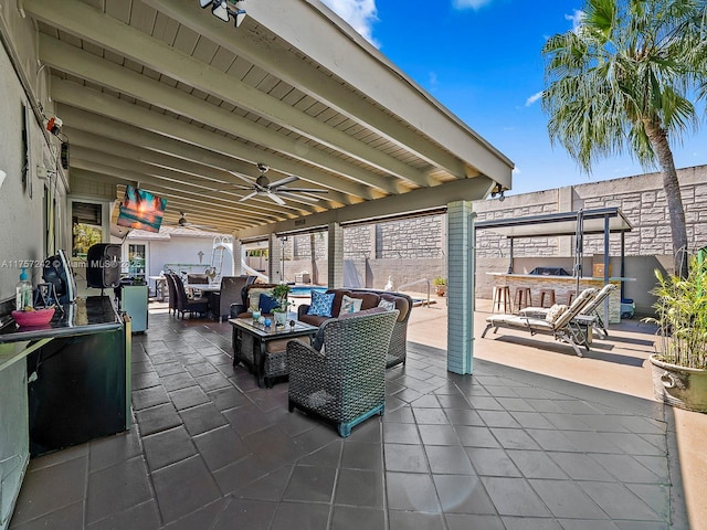 view of patio / terrace with an outdoor living space, outdoor dining area, and ceiling fan