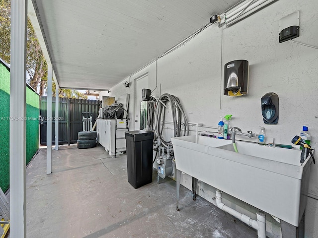 view of patio / terrace featuring a sink and fence