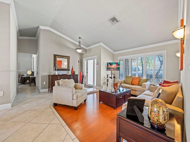 living area with vaulted ceiling, light tile patterned floors, crown molding, and visible vents