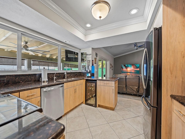 kitchen with crown molding, ceiling fan, wine cooler, appliances with stainless steel finishes, and light tile patterned flooring