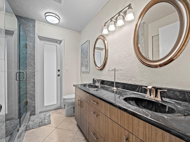 full bathroom featuring a shower stall, toilet, tile patterned floors, and a sink