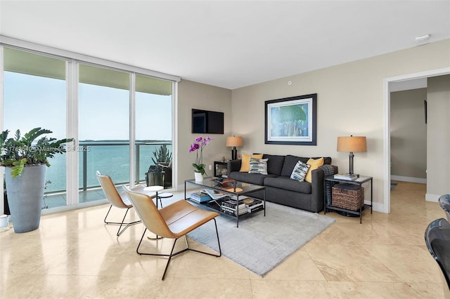 living room with baseboards and floor to ceiling windows