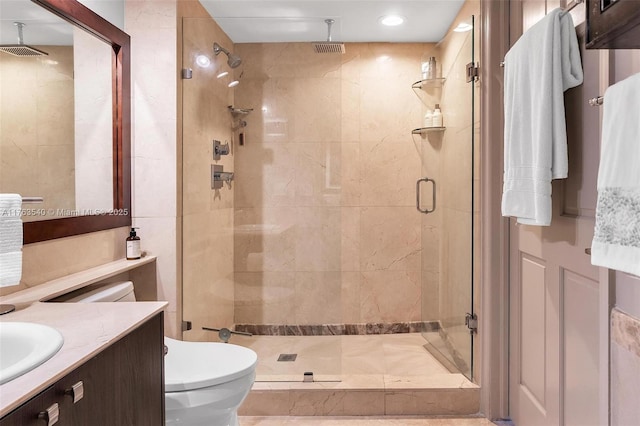 full bathroom with visible vents, toilet, a stall shower, and vanity