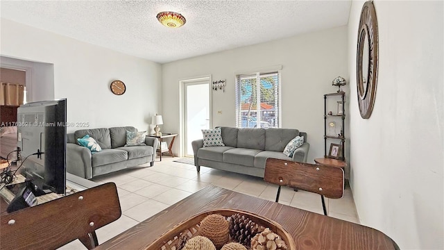 living area featuring light tile patterned floors and a textured ceiling