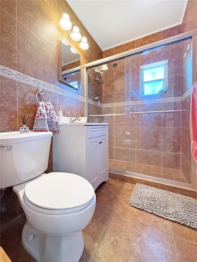 full bathroom featuring toilet, tile walls, a stall shower, and vanity