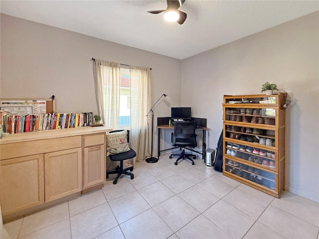 office space featuring light tile patterned floors, a ceiling fan, and a textured ceiling