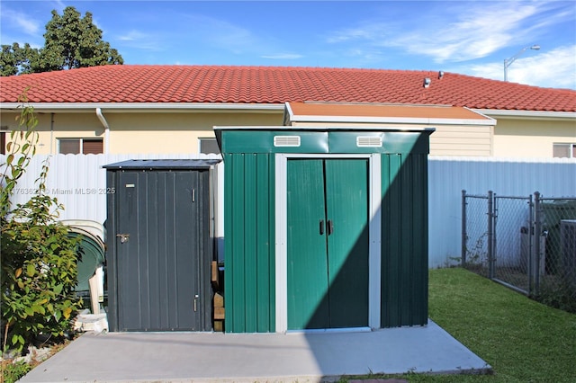 view of shed with a gate and fence